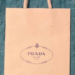 Prada gift bag. White with white handles and Black Prada monogram, 10”x6”x3”